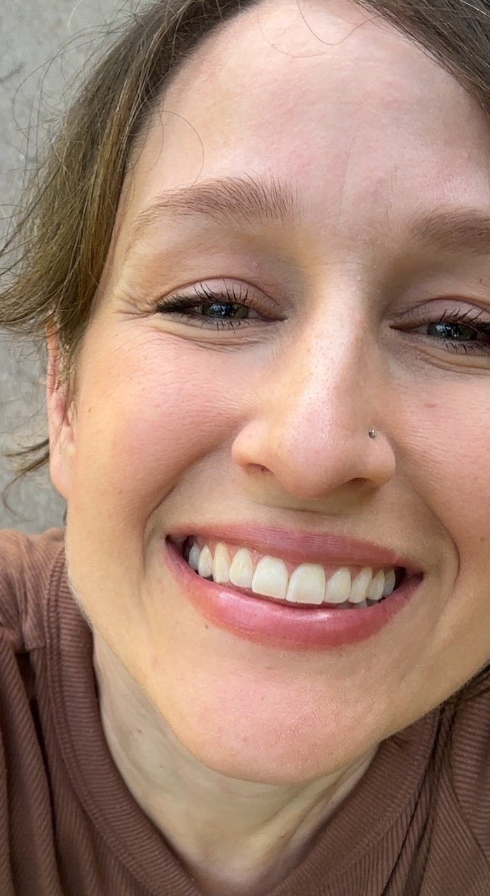 Carrie now, smiling, outdoors